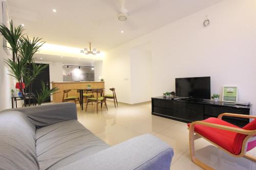 a living room with a couch and a flat screen tv at Vista Horizon Melaka in Melaka