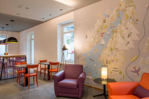a restaurant with a christmas tree mural on the wall at Holiday IV Gardan in Riva del Garda