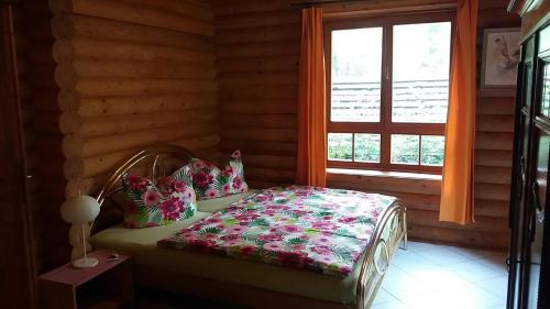 Postel nebo postele na pokoji v ubytování Holzhaus am See