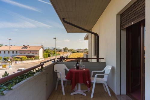 a table and chairs on a balcony with a view of a street at Park Hotel Ristorante Ca' Bianca in Istrana