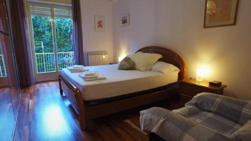 a bedroom with a bed and a couch and a window at Camping Jonio in Catania