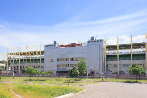 a large white building in front of a stadium at Hotel Obolon-Arena in Kyiv