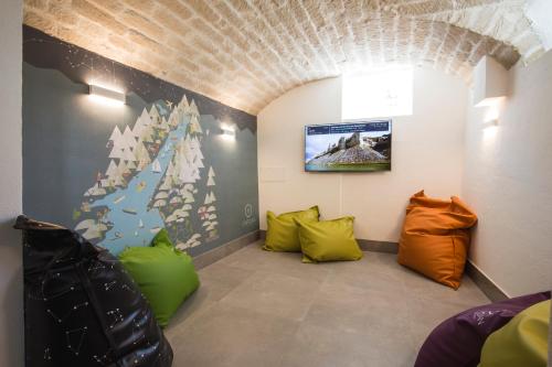 a room with colorful pillows and a wall at Holiday IV Gardan in Riva del Garda