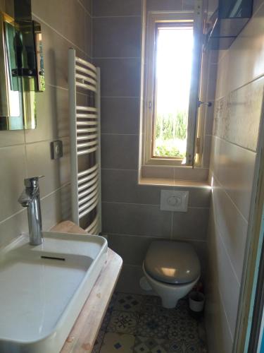 une salle de bain avec un lavabo et des toilettes et une fenêtre dans l'établissement Bord de mer avec vue, à Mandelieu-la-Napoule