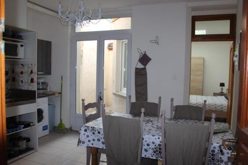 a dining room with a table and chairs and a window at Apparts St Sépulcre in Saint-Omer