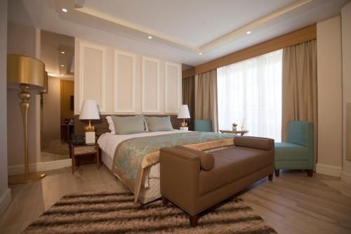 a bedroom with a bed and a couch and a chair at The Escape Hotel in Ağva