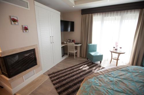 a hotel room with a fireplace and a bedroom at The Escape Hotel in Agva