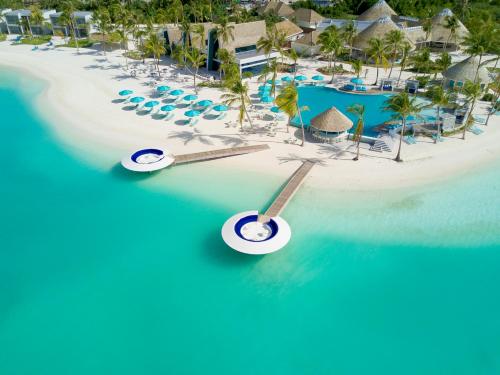 an aerial view of a resort on a tropical island at Kandima Maldives in Kudahuvadhoo