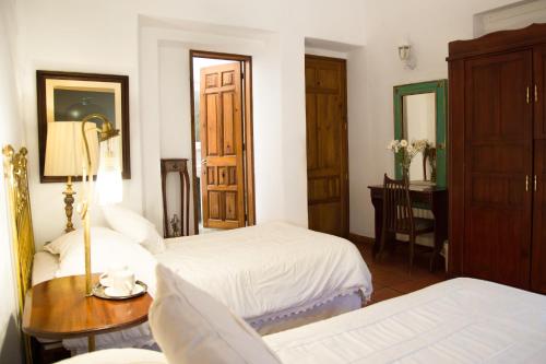 Ένα ή περισσότερα κρεβάτια σε δωμάτιο στο Casa de Siete Balcones Hotel Boutique