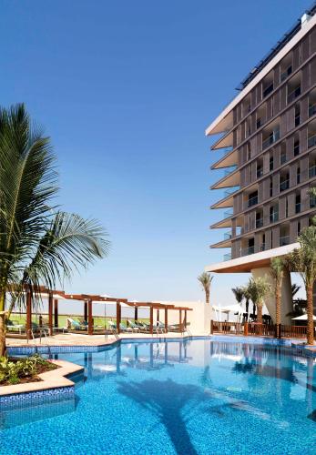 a large swimming pool in front of a hotel at Radisson Blu Hotel, Abu Dhabi Yas Island in Abu Dhabi