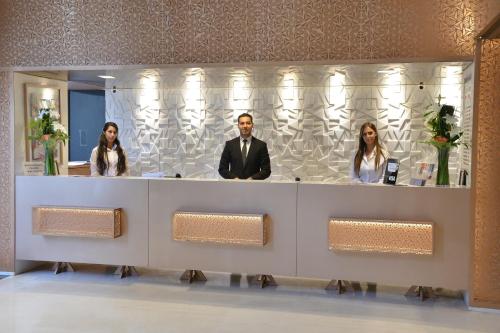 a group of people standing behind a reception desk at Oum Palace Hotel & Spa in Casablanca
