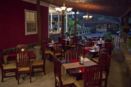 a restaurant with tables and chairs in a room at Hotel Hacienda El Rodeo in Rodeo