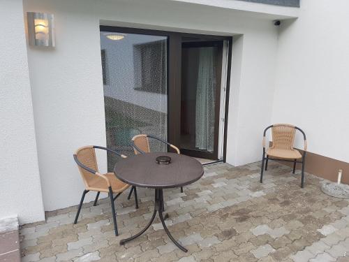 a table and two chairs on a patio at Landhaus Aggenstein in Haldensee