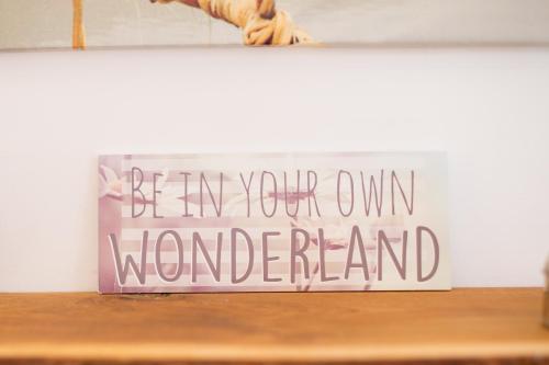 a sign that says be my own wonderland on a shelf at JustB Edinburgh in Edinburgh