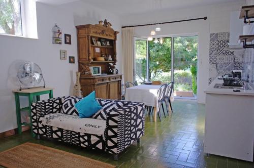 a kitchen and living room with a table and chairs at Lei Home in Cascais