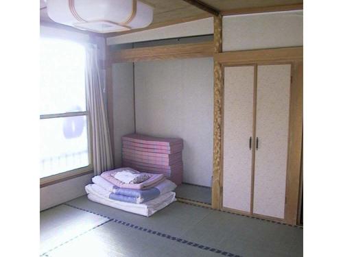 a room with two bunk beds and a window at Sapporo Inn Nada in Sapporo