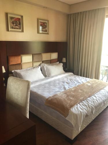 a bedroom with a large bed and a window at Ana's Apartment in Chakvi Oasis in Chakvi