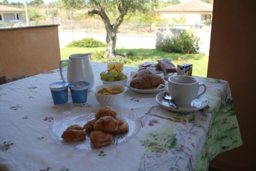 a table with pastries and cups of coffee on it at Il Maestrale B&B in Castellabate