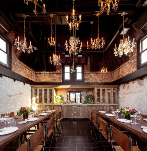 a large dining room with long tables and chandeliers at The Broadview Hotel in Toronto