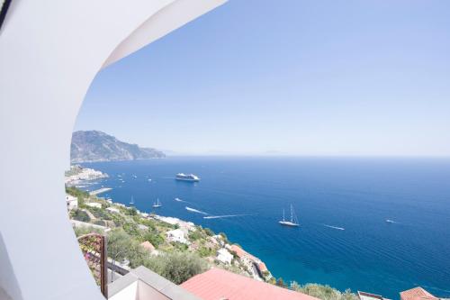 a view of the ocean with boats in the water at Hotel Villa Felice Relais in Amalfi