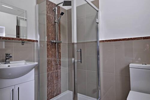 a bathroom with a shower and a sink at RBS Hotel in Rochester