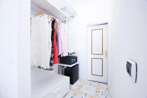 a room with a door and a closet with clothes at Hotel Villa Felice Relais in Amalfi
