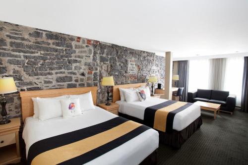 Säng eller sängar i ett rum på Hotel du Vieux Quebec
