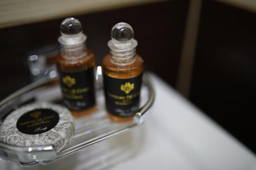two bottles of honey sitting on a metal shelf at Penzion Sokolská in Zlín