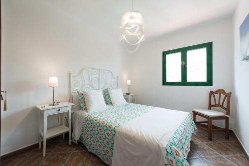 Postel nebo postele na pokoji v ubytování Casa Panchita -Maravillosas vistas al mar y montaña