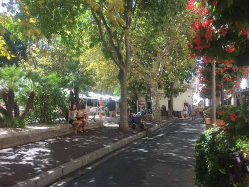 two people sitting on a bench in a park at Appart' Vieil Antibes in Antibes