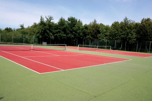 
a tennis court with two tennis racquets on the court at Fletcher Resort-Hotel Amelander Kaap in Hollum
