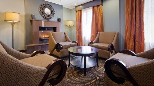 a living room with chairs and a fireplace at Best Western Plus Coldwater Hotel in Coldwater