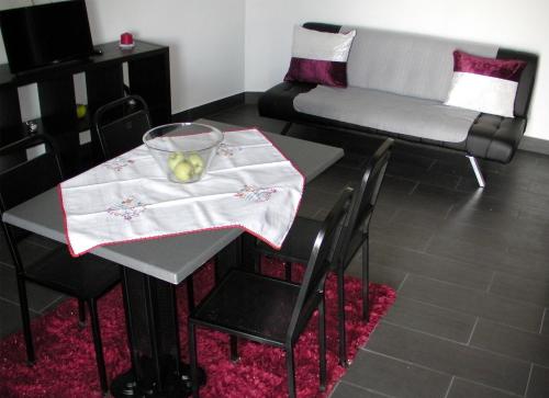 a table and chairs with a table and a couch at Alojamento Costa & Dias in Vila Verde