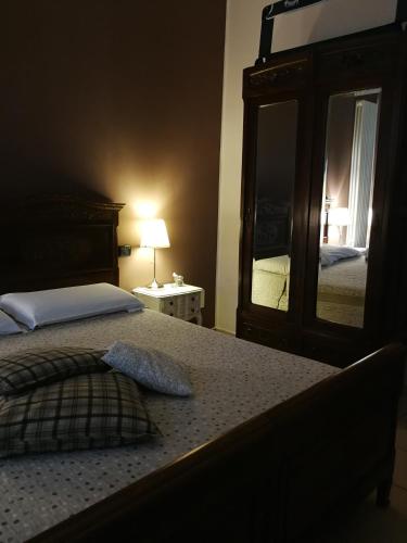 a bedroom with a bed and a large mirror at B&B Cascina Barolo in Turin