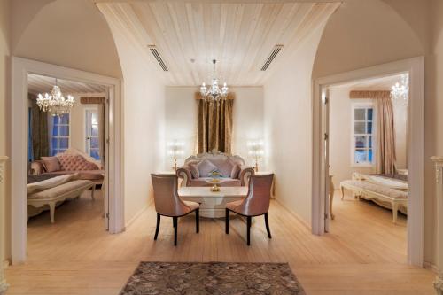 a living room with a table and chairs and a couch at Elegance East Hotel in Antalya