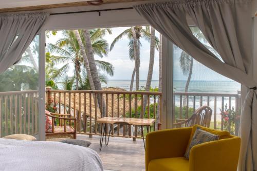 a bedroom with a bed and a view of the ocean at Aaki Hotel in Las Peñitas