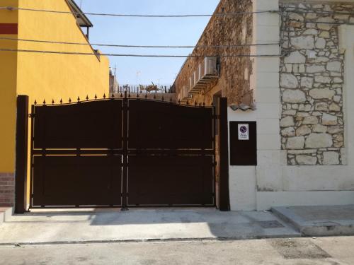 a black gate in front of a building at La casa di Bice in Cassibile