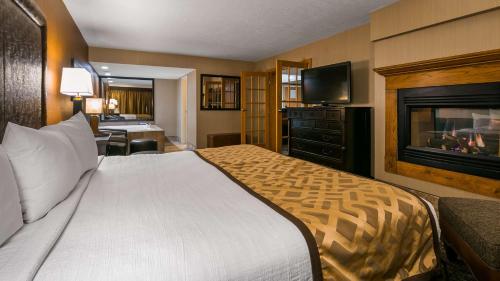 a hotel room with a bed and a television at Best Western Ramkota Hotel in Rapid City
