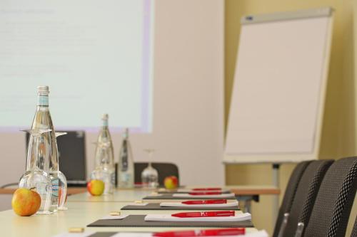 a long table with bottles and books on it at Hotel Olten Swiss Quality in Olten