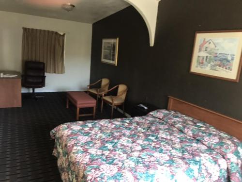 a hotel room with a bed and a desk at Galleria Inn Montclair/Ontario in Montclair