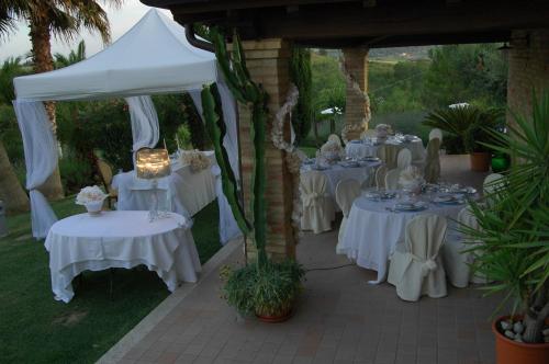 a group of tables with white table cloths on them at Agriturismo Tenuta Sol Alto in Monsampolo del Tronto