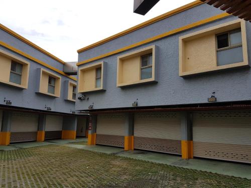 two story buildings with garages on the side of them at 溪湖汽車旅館 in Xihu