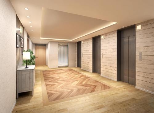a hallway with wood flooring and a room with a wall at Sotetsu Fresa Inn Tokyo Kinshicho in Tokyo