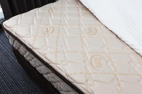 a mattress sitting on top of a bed at Global Resort Miyajima View in Hatsukaichi