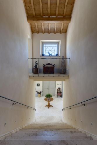a large room with a staircase and a window at Relais Il Margarito in Montefano