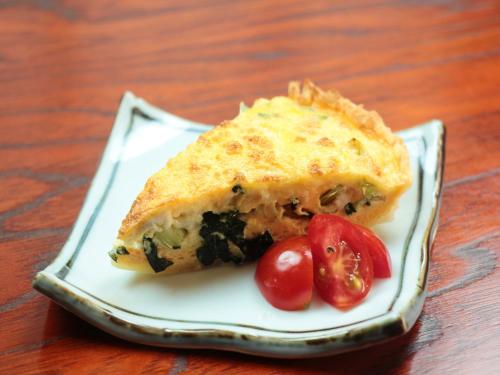 a piece of food on a plate with tomatoes at Chouchinya in Nozawa Onsen
