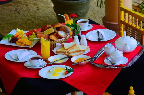 a table with a breakfast of eggs bread and toast at Mount View in Polonnaruwa