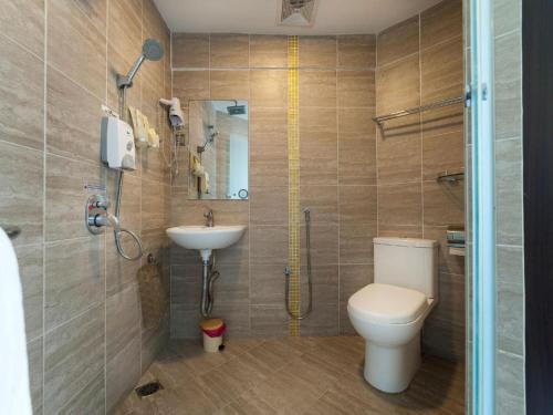a bathroom with a toilet and a sink at One Avenue Hotel in Petaling Jaya