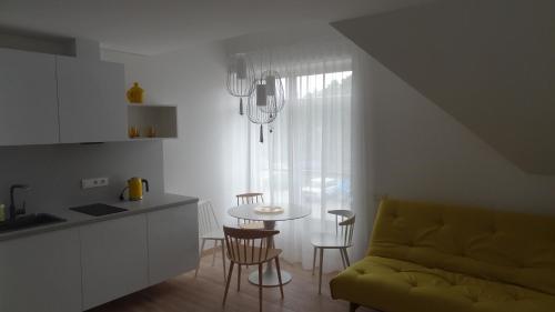 a kitchen and dining room with a table and chairs at Preila Holiday in Preila