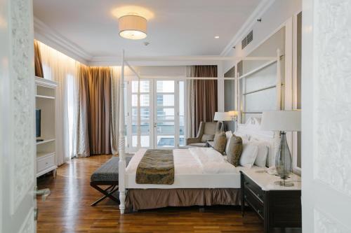 a bedroom with a bed with a large mirror at Ascott Jakarta in Jakarta